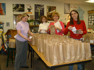 ABC members stuff goodybags to reward students for academic achievement.